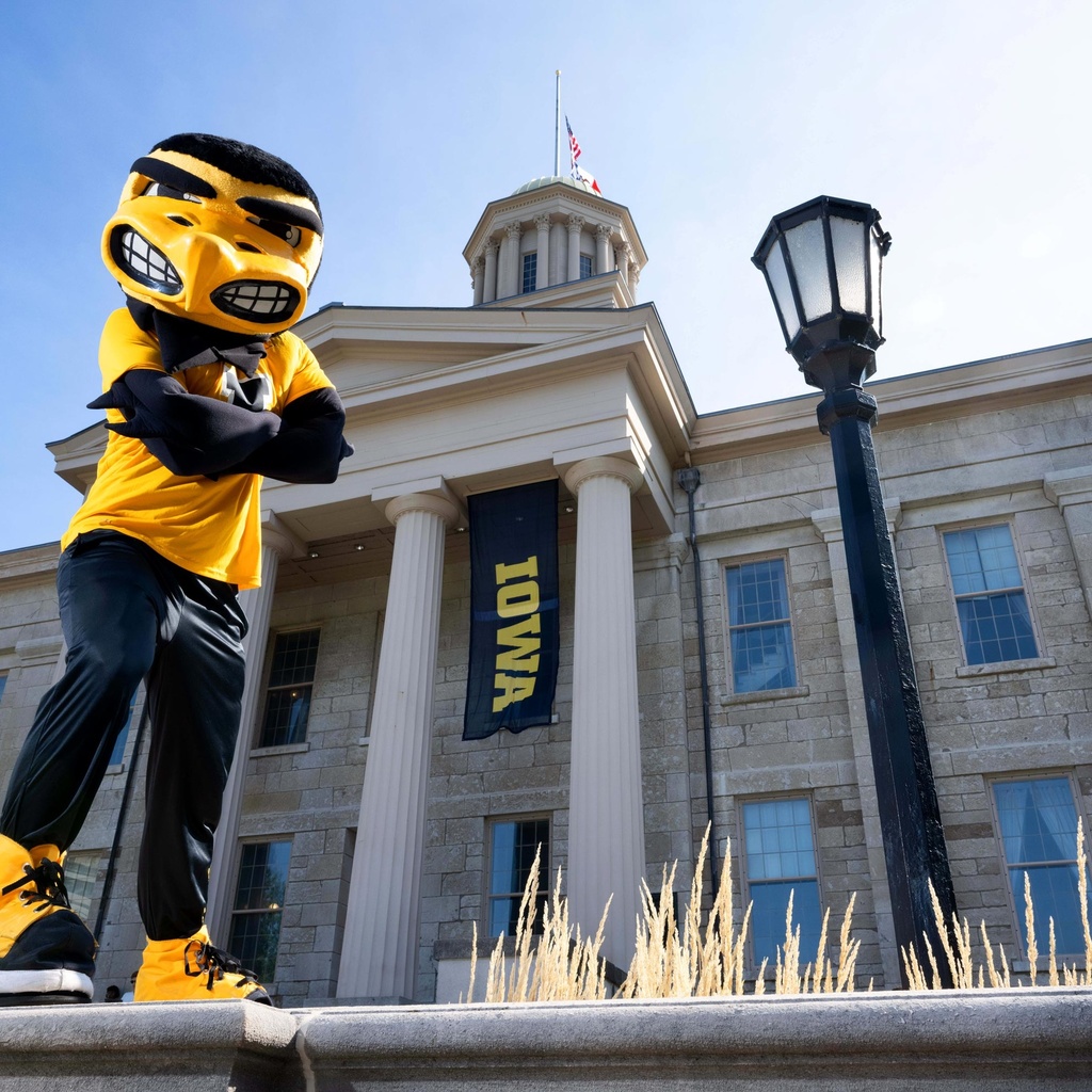 Herky standing in front of Old Capitol